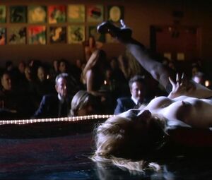 Jessica Chastain moves around pole and pulls dress down showing boobies in Jolene (2008)
