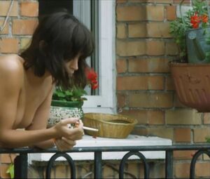 Lewd Vimala Pons is watched by man smoking on balcony in J'aurais Pu รชtre Une Pute